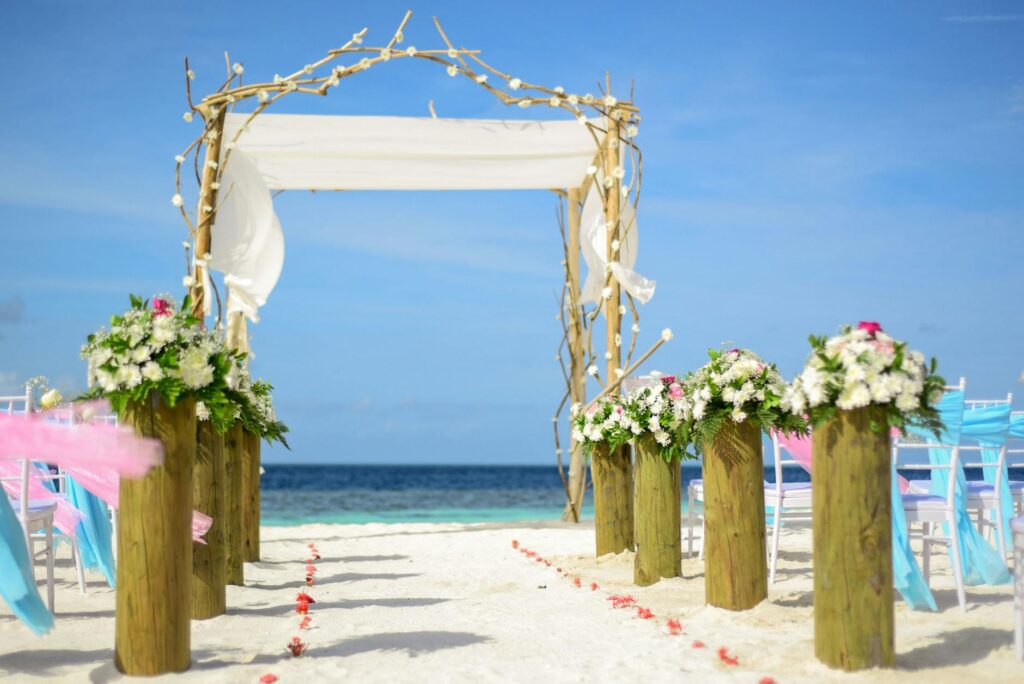 A beautiful beach ceremony setup showcasing floral arrangements featuring beach wedding flowers Las Vegas