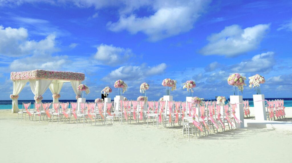A beautiful beach wedding setup in Las Vegas with floral decorations and an altar. — beach wedding packages Las Vegas