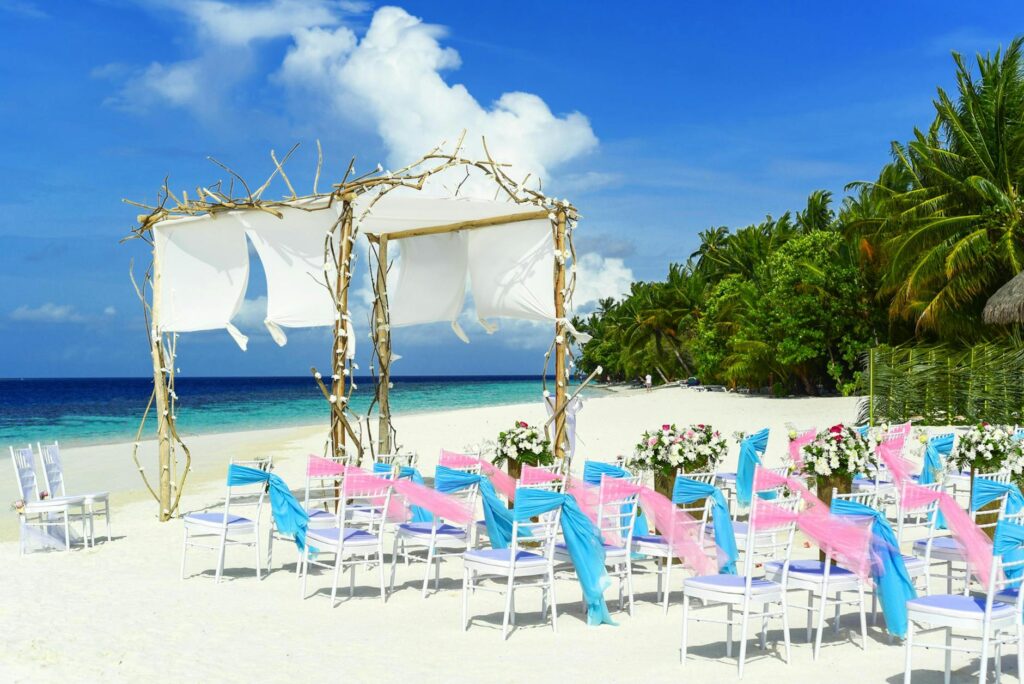 A beautifully decorated beach wedding setup with flowers and chairs. — romantic beach wedding Las Vegas