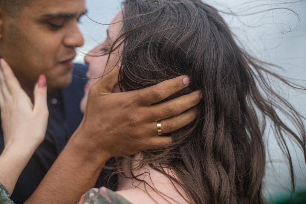 A close-up of a couple with the ocean in the background, highlighting the emotional moments. — beach wedding photographe…