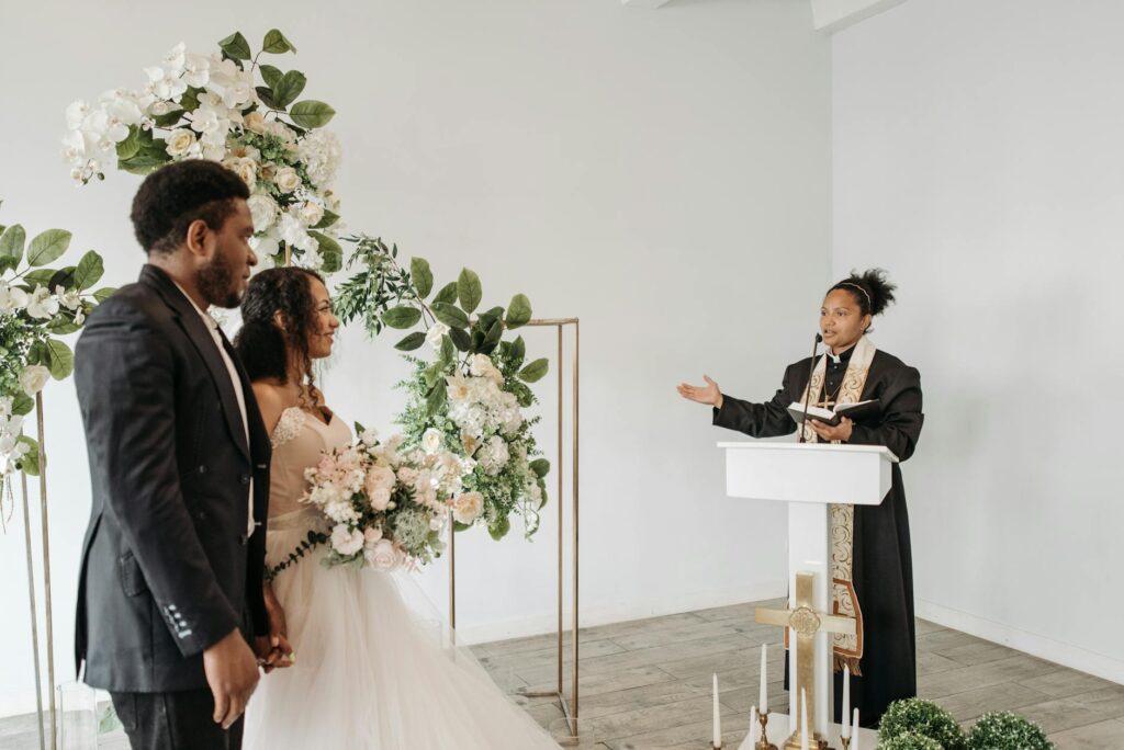 A close-up of an officiant speaking with a couple during their rehearsal — Las Vegas wedding officiants