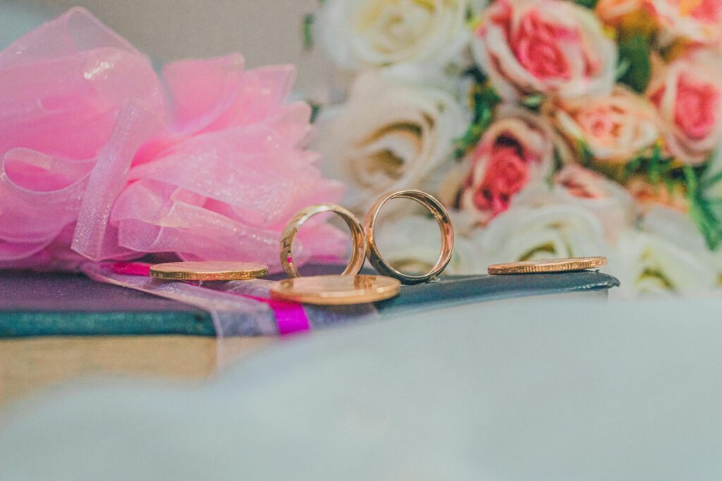 A close-up of wedding details, such as rings and flowers, being captured by a photographer. — wedding photographers Las …