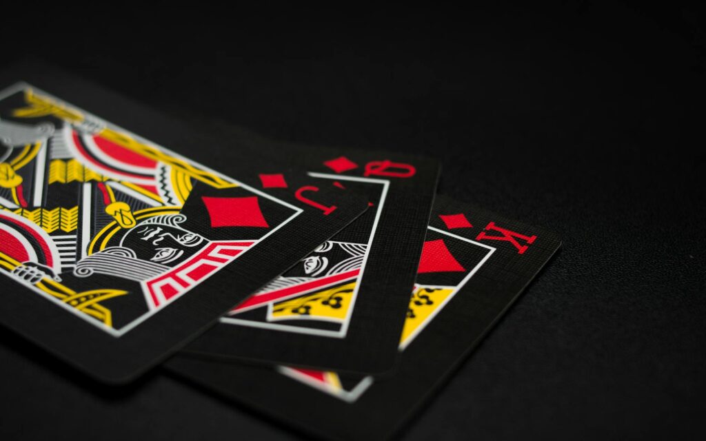 A close-up of wedding rings placed on a deck of cards, highlighting a casino theme. — casino wedding photography Las Vegas