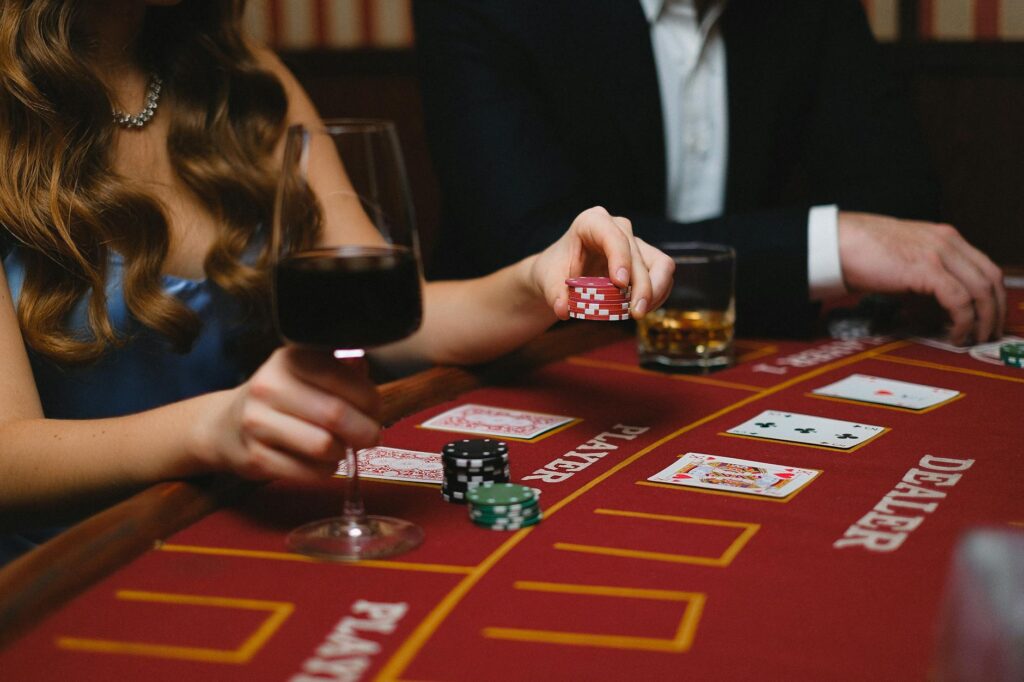 A colorful wedding cocktail bar featuring casino-themed drinks alongside a poker table. — casino games wedding reception