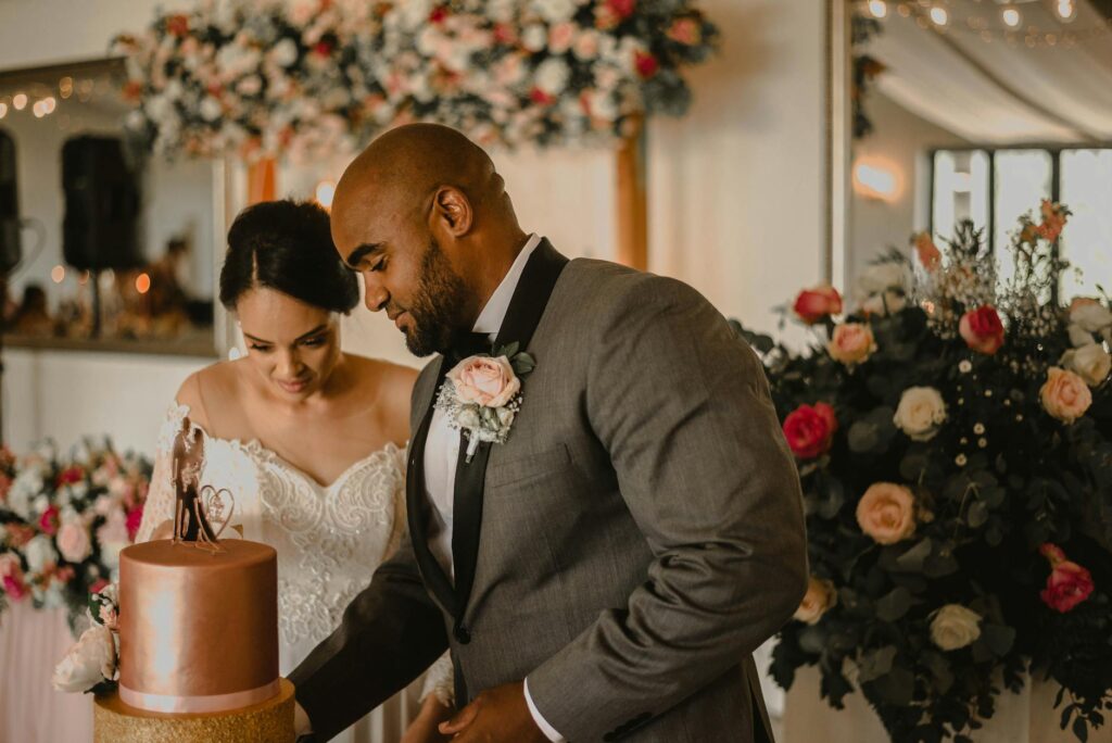 A couple cutting their wedding cake at a cozy, affordable reception venue. — affordable Vegas wedding reception tips