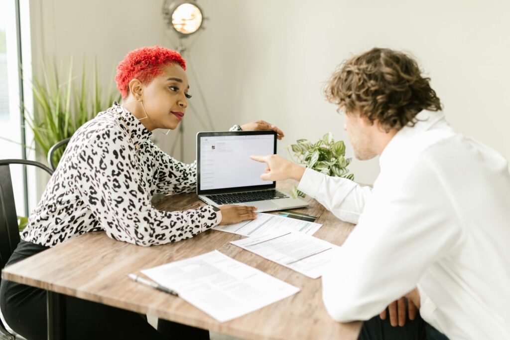 A couple discussing plans with a wedding planner over a laptop. — choosing wedding planner Las Vegas