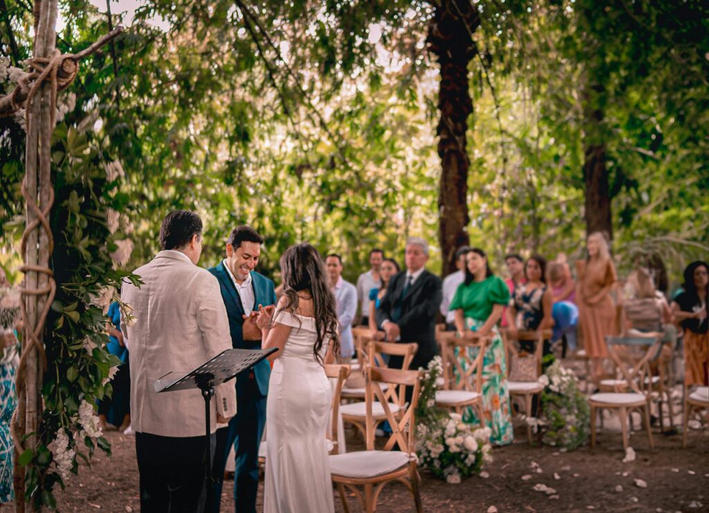 A couple enjoying an outdoor wedding ceremony, with guests in attendance. — casino wedding date tips