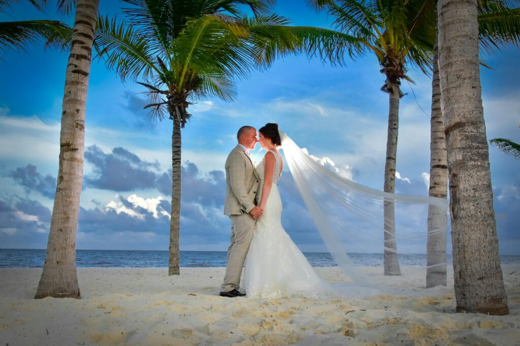 A couple exchanging vows on a picturesque Las Vegas beach at sunset. — romantic beach wedding Las Vegas