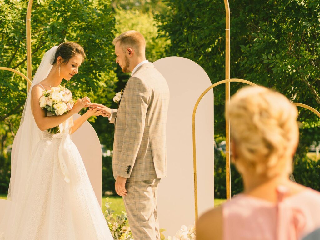 A couple exchanging vows outdoors, with the beautiful Las Vegas skyline in the background. — best times to get married L…