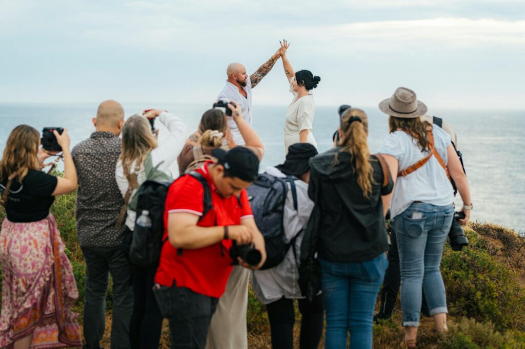 A couple posing with a Las Vegas wedding photographer at a scenic venue. — Las Vegas wedding photographers