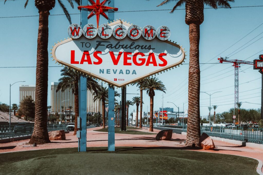 A couple taking a romantic photo in front of a famous Las Vegas casino backdrop. — pros and cons casino wedding Las Vegas