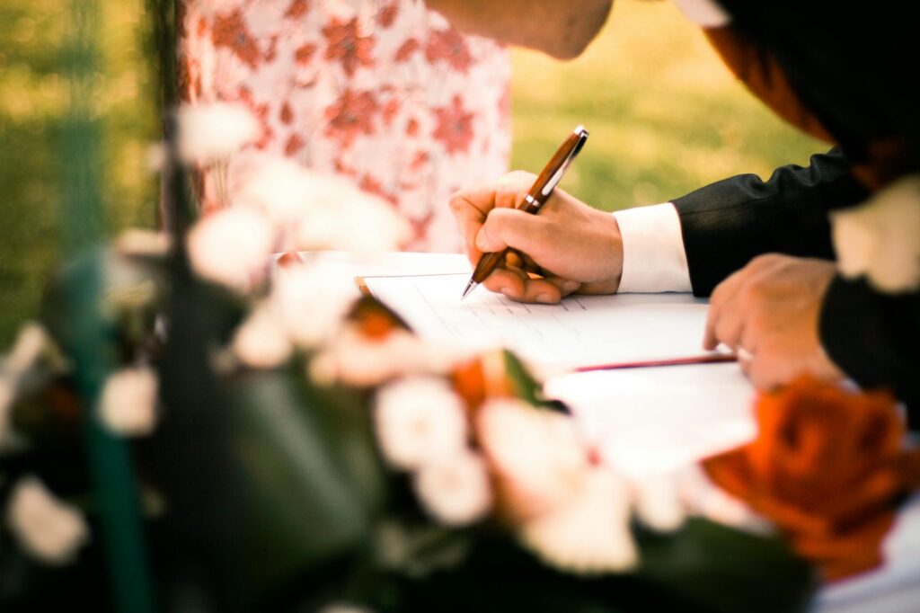 A couple writing their personalized wedding vows at a casino-themed table. — writing casino wedding vows