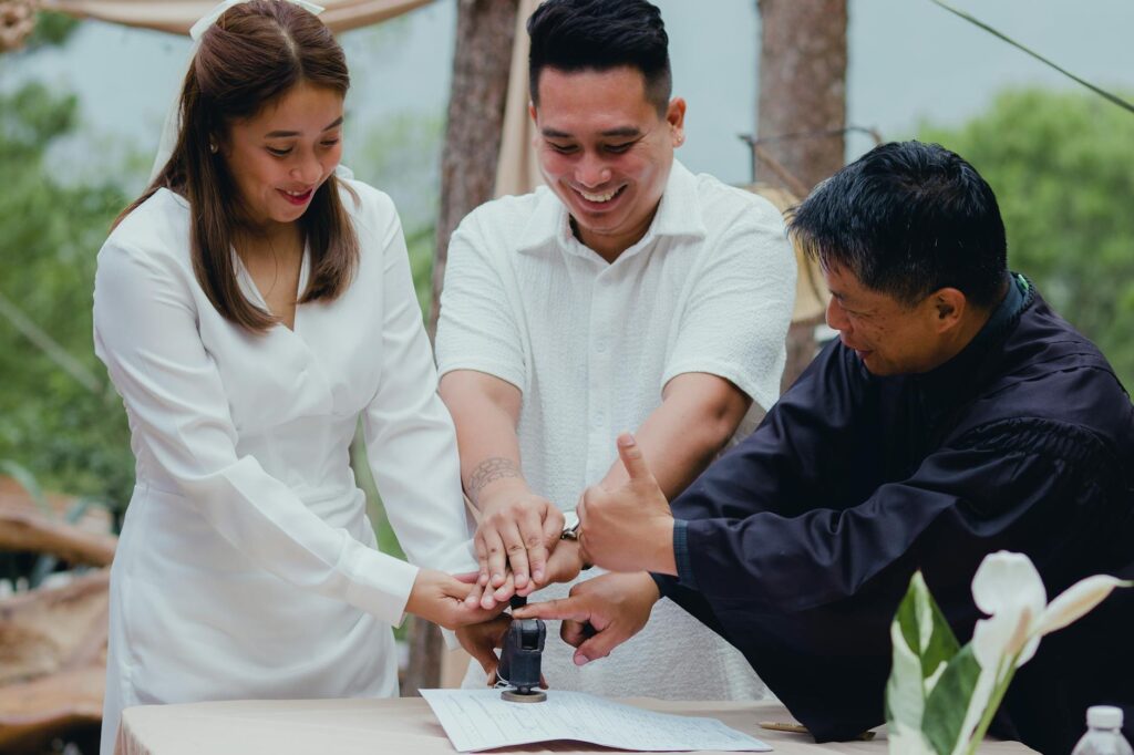 A happy couple exchanging rings, with their beach wedding officiant smiling in the background. — beach wedding officiant…