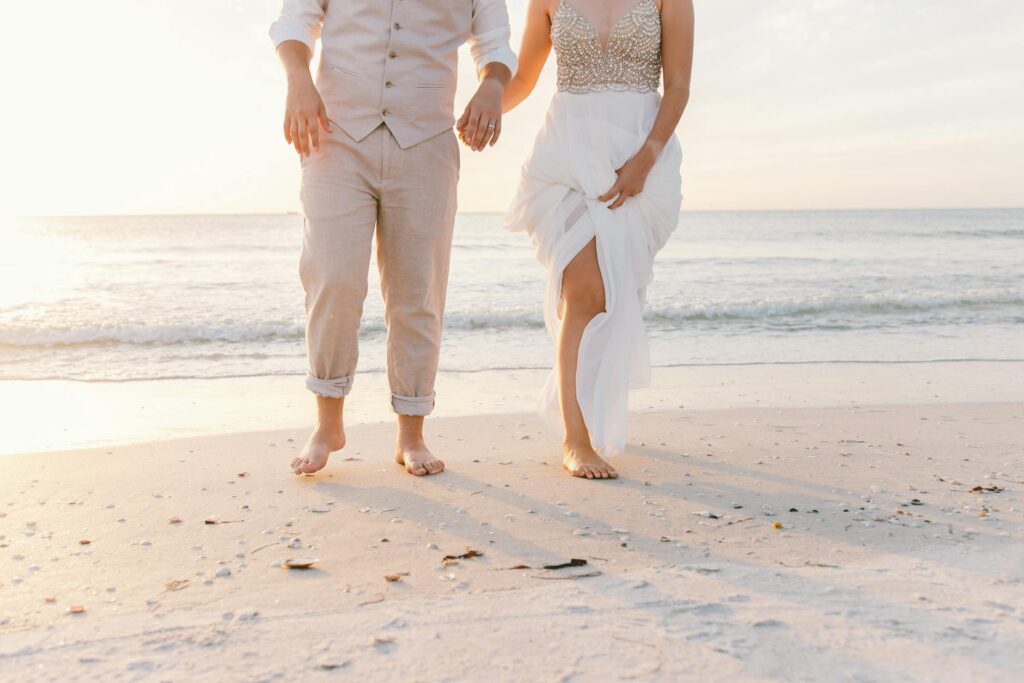 A happy couple exchanging vows on a beach during sunset. — beach wedding checklist Las Vegas