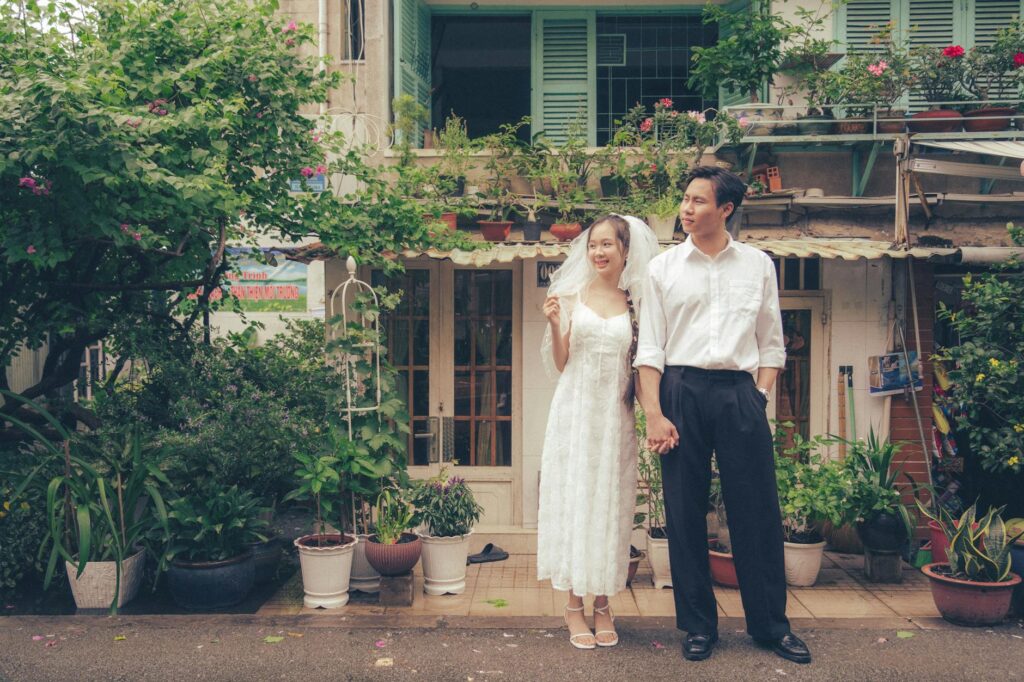 A happy couple surrounded by lush greenery and minimalist floral decor — affordable wedding flowers Las Vegas