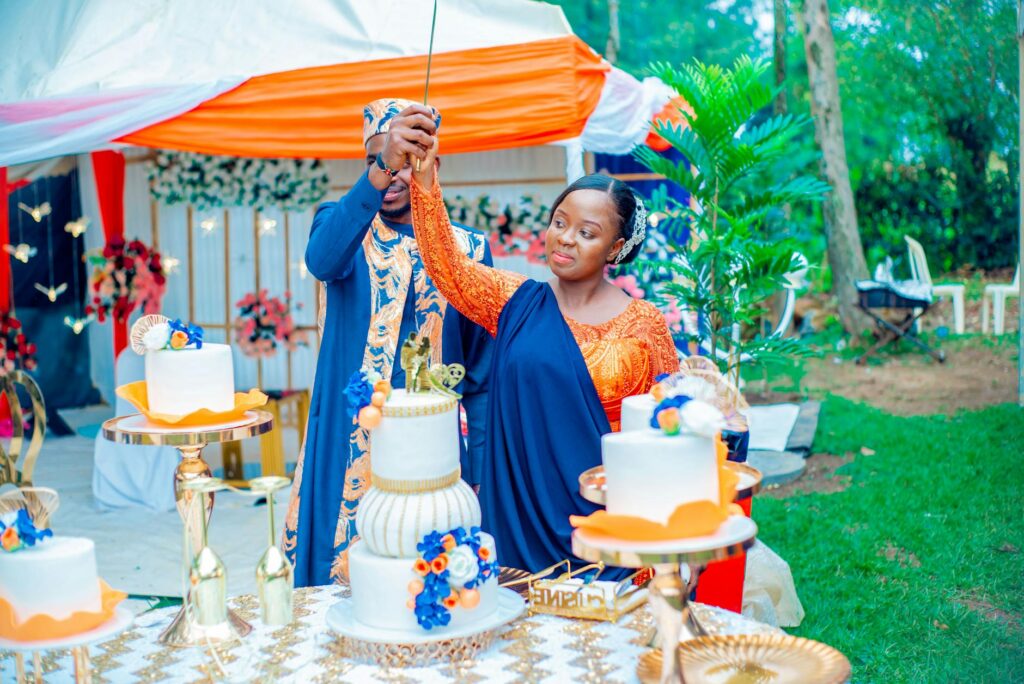 A joyful couple celebrating with a beach-themed wedding cake and decorations. — romantic beach wedding Las Vegas