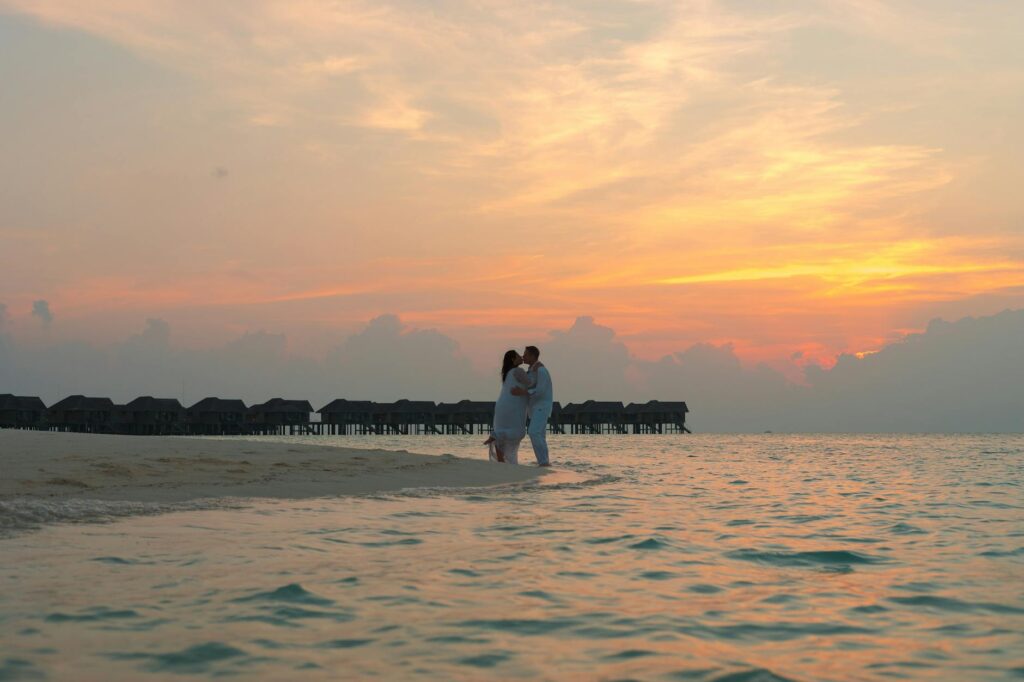 A picturesque sunset over a Las Vegas beach wedding scene, creating a romantic atmosphere. — destination beach wedding L…