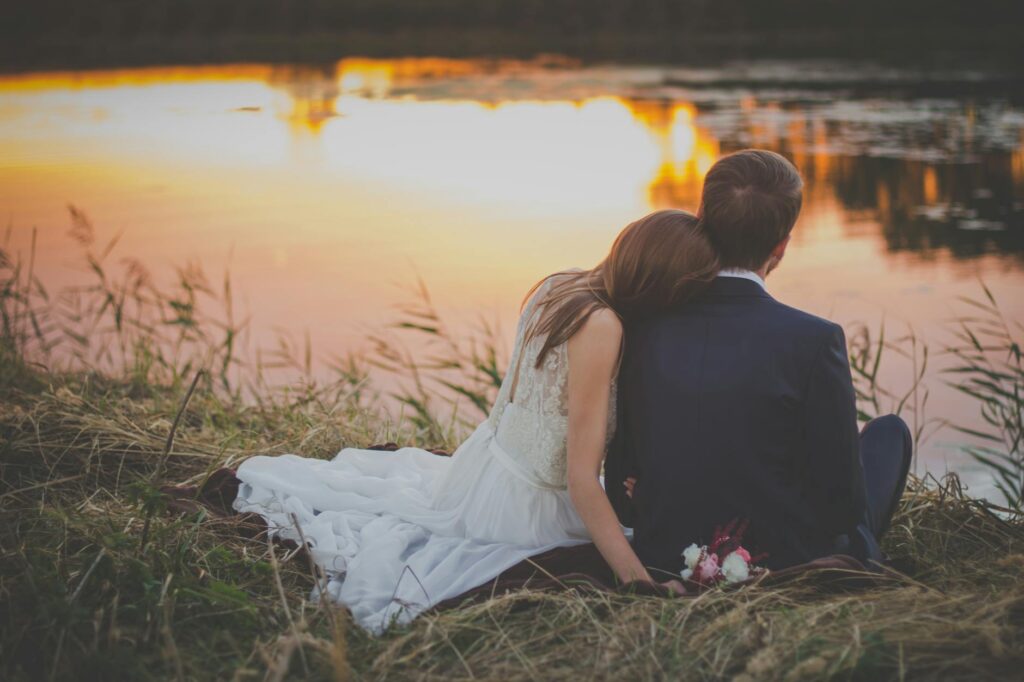 A picturesque sunset view over Lake Las Vegas, with a bride and groom enjoying a romantic moment at the water's edge. — …