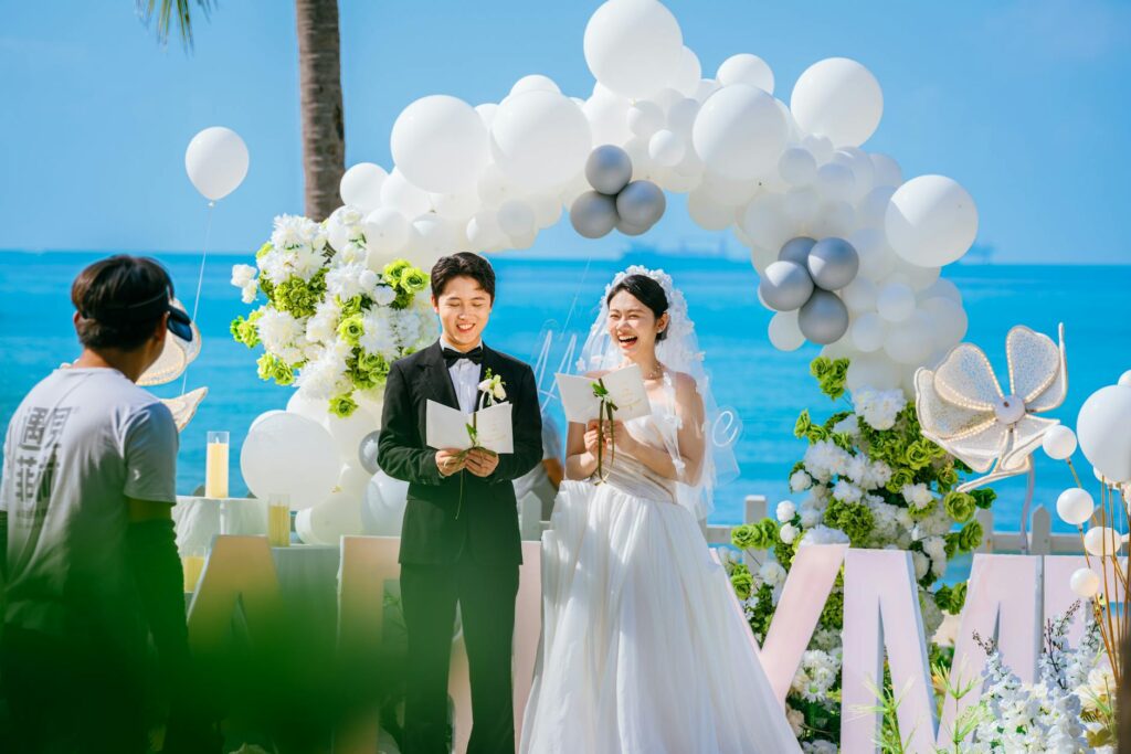 A wedding planner discussing plans with the couple on the beach. — stress-free beach wedding Las Vegas