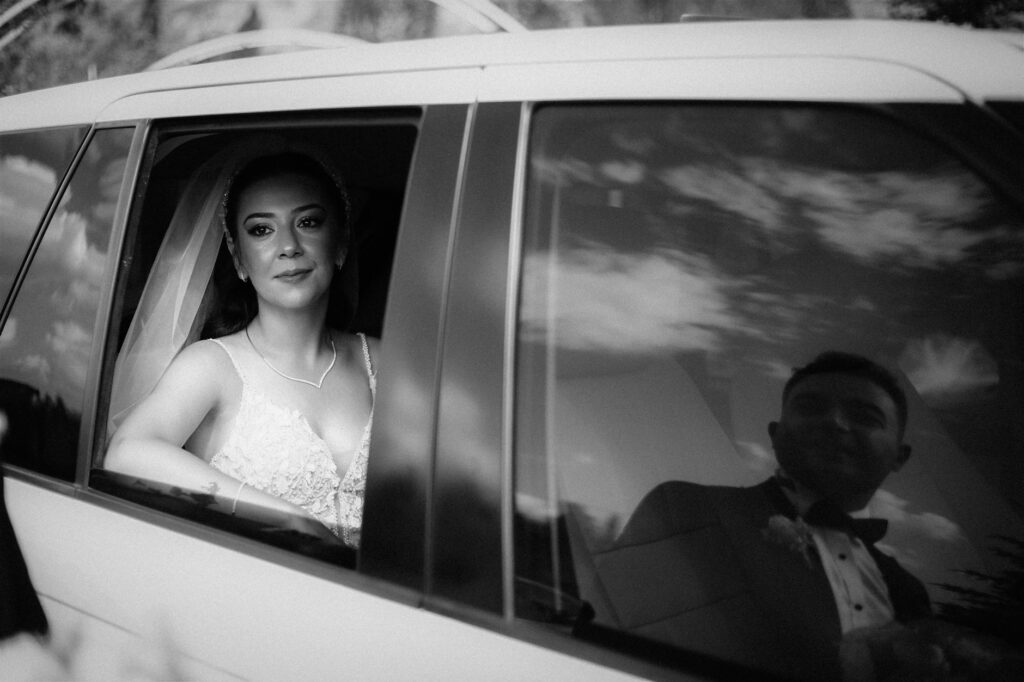 An artistic black and white portrait of a bride and groom reflecting on their day, taken in a vintage Las Vegas venue. —…