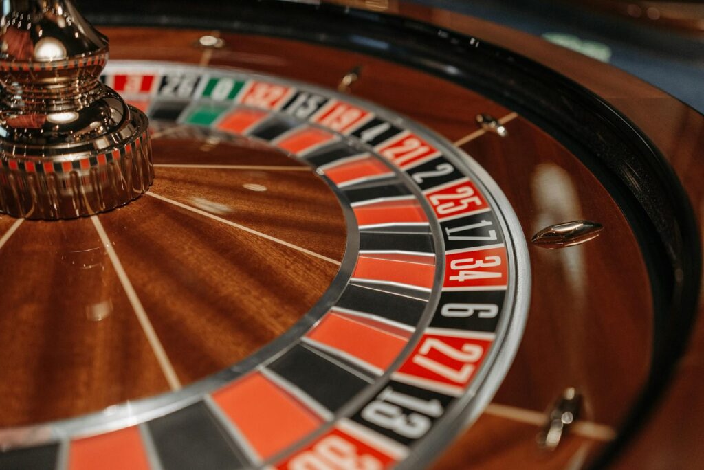 An elegant roulette wheel at a wedding reception, surrounded by excited guests. — casino games wedding reception
