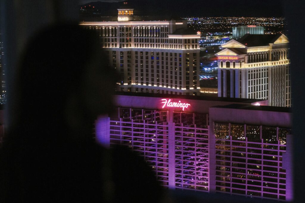An officiant holding a wedding license with the Las Vegas skyline in the background. — casino wedding officiants Las Vegas