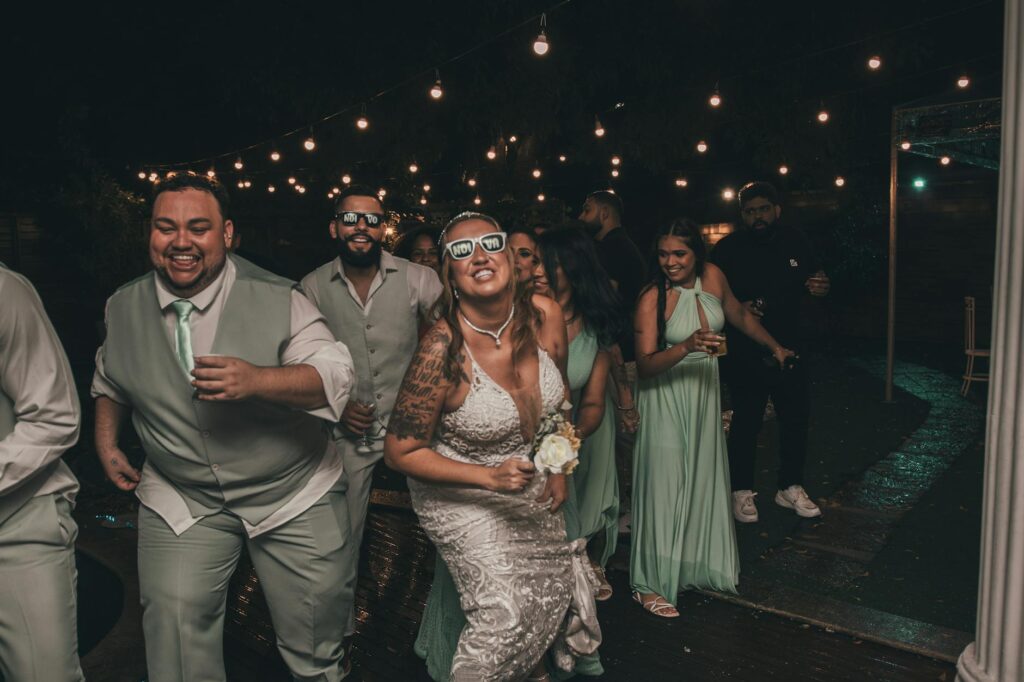 Bridesmaids and groomsmen laughing together at a casino-themed wedding reception. — casino wedding photography Las Vegas