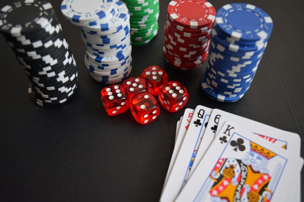 Decorative centerpieces featuring dice and playing cards at a wedding table. — casino wedding entertainment Las Vegas