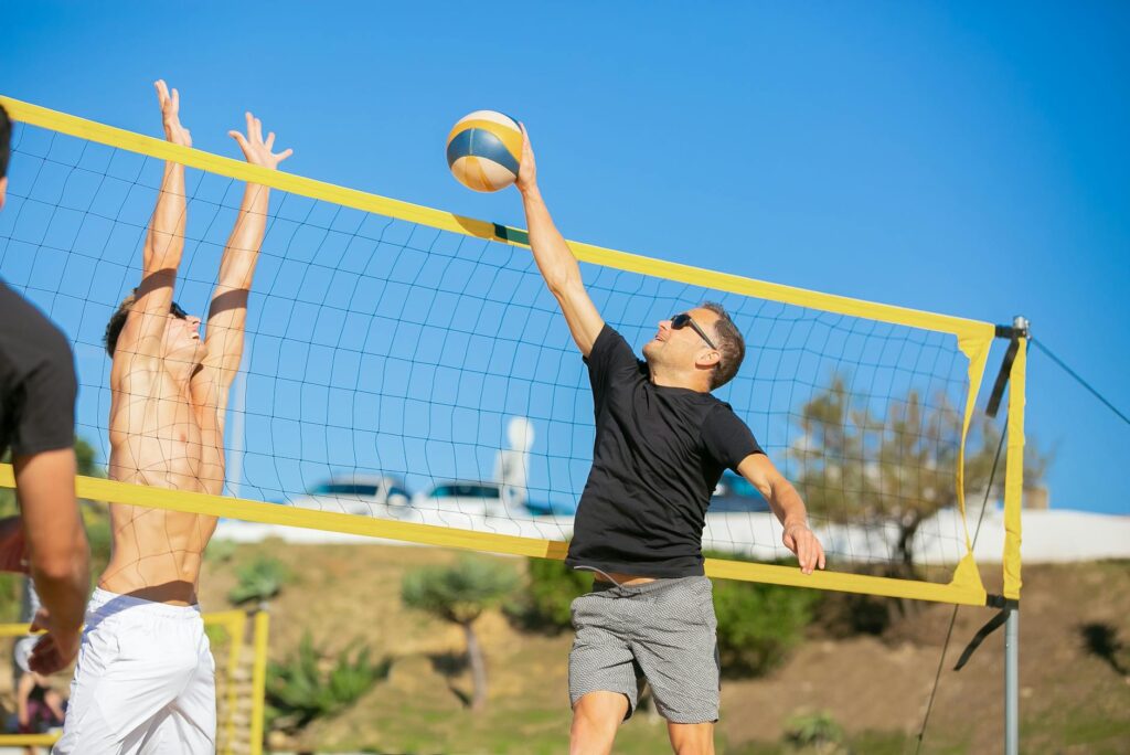 Guests playing beach volleyball during a wedding celebration. — beach wedding activities Las Vegas