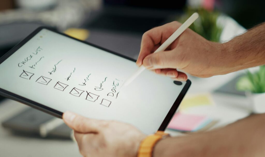 A checklist on a tablet, representing the planning and coordination services offered. — LV wedding concierge