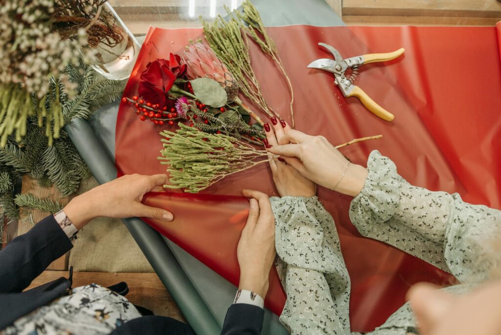 A close-up of a DIY flower arrangement being prepared by a couple. — Las Vegas wedding flowers