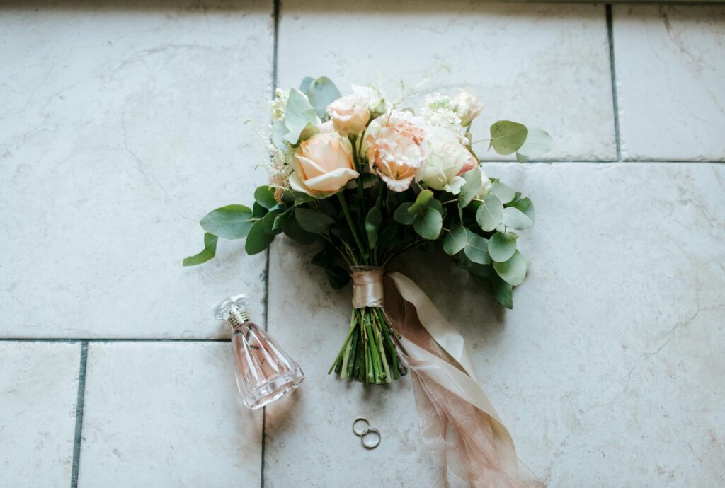 A close-up of a beautifully arranged wedding bouquet with a photographer's equipment in the background. — Las Vegas wedd…