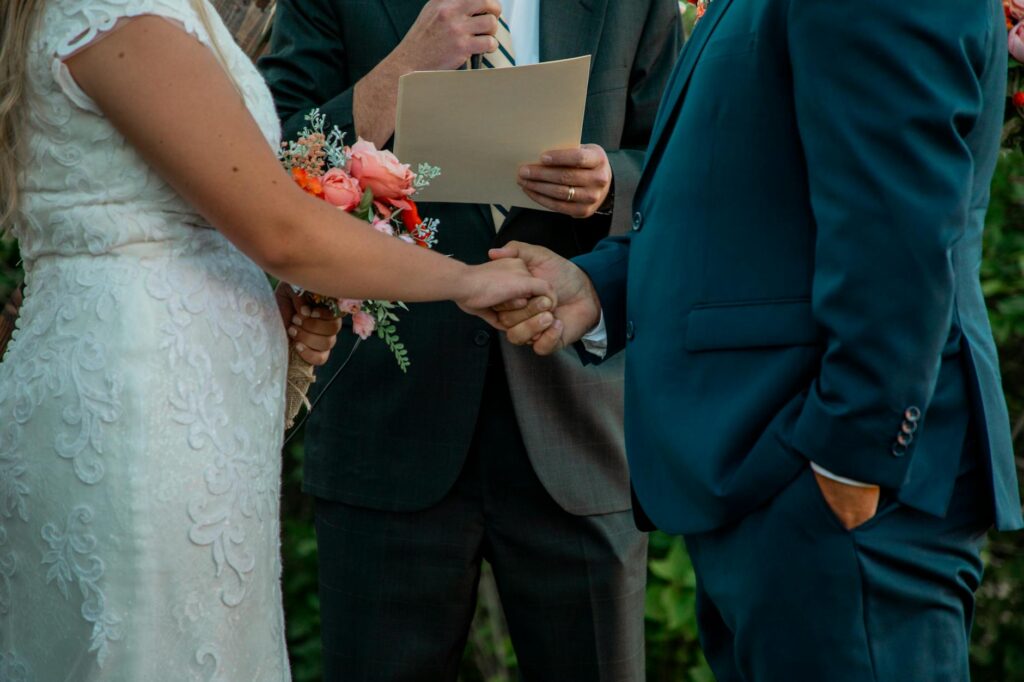 A close-up of a wedding officiant reading vows at a picturesque Las Vegas location, highlighting the emotional connection.…