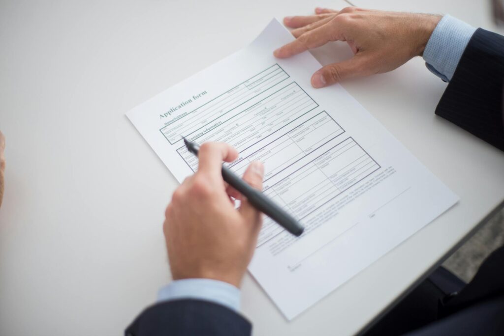 A close-up of the marriage license application form with a pen ready to sign. — Las Vegas wedding license requirements