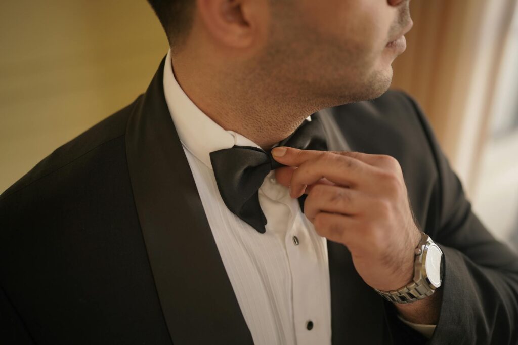 A close-up of wedding attire, including a wedding dress and tuxedo with Las Vegas themed accessories — Las Vegas wedding…