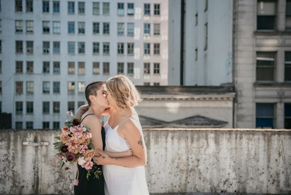 A couple celebrating their elopement with a dinner at a rooftop restaurant, emphasizing post-elopement festivities. — La…