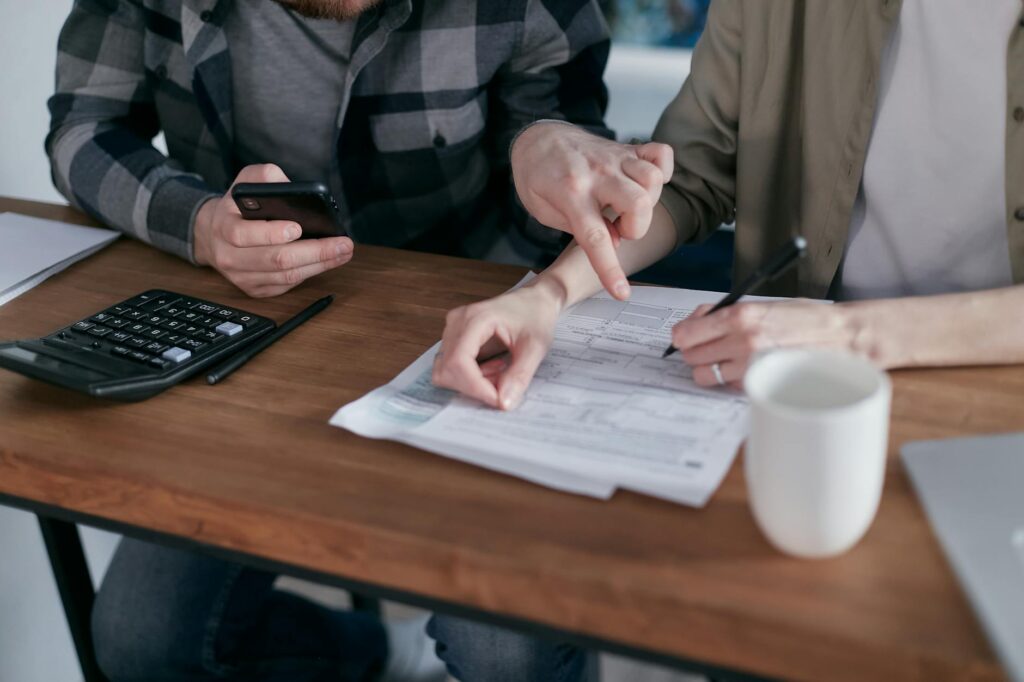 A couple discussing their wedding budget with a planner — Las Vegas wedding budgeting tips