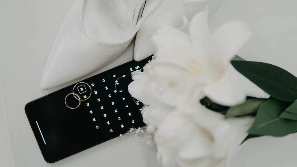 A creative flat lay of wedding rings and flowers, styled with a Las Vegas backdrop. — wedding photographers Las Vegas