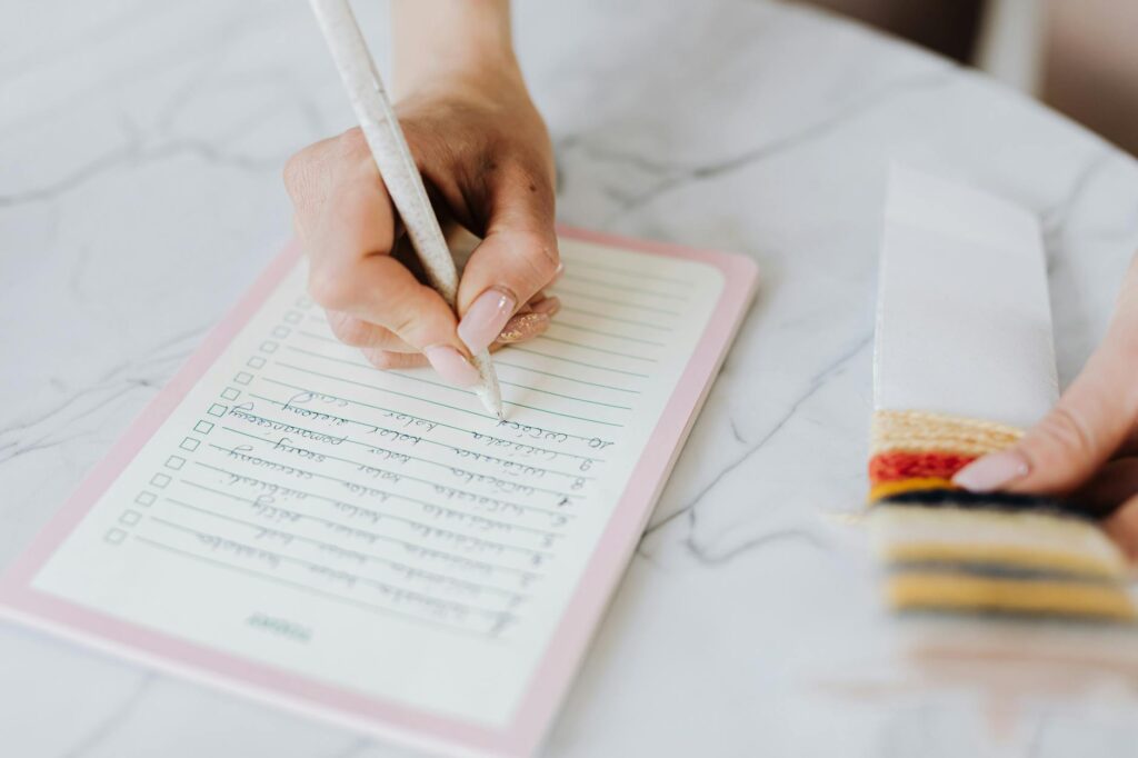A detailed wedding planning checklist spread out on a table, with colorful pens and notes. — questions for wedding planner