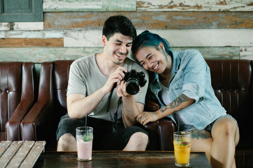 A joyful couple with a photographer capturing candid moments. — elopement planning Las Vegas