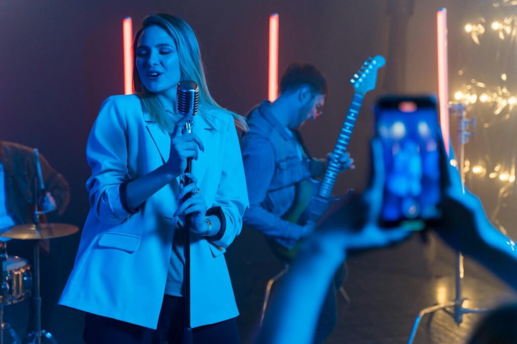 A lively rock 'n' roll wedding scene, showcasing a live band playing on stage with guests dancing. — unique wedding them…