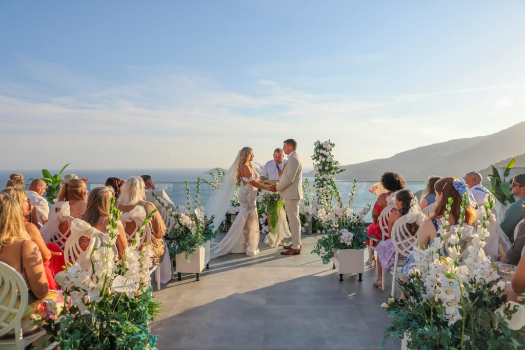 A sunny summer wedding ceremony on a rooftop with the Strip in view — best time to get married Las Vegas