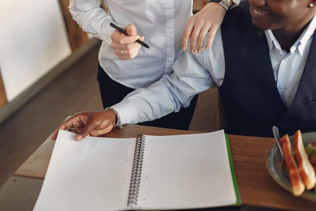 A wedding concierge discussing plans with a couple at a café. — Las Vegas wedding budgeting