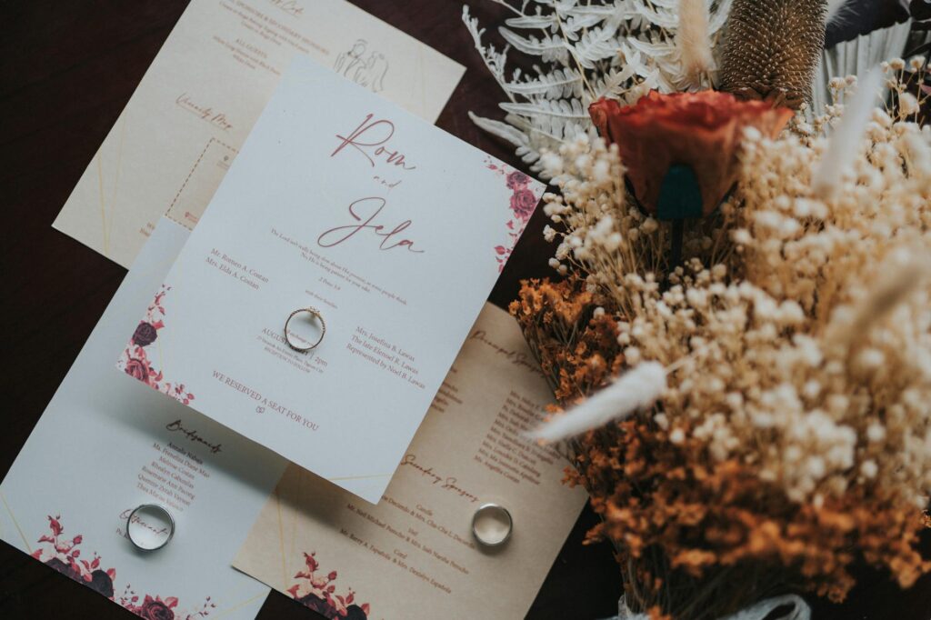 An elegant wedding invitation suite laid out with wedding planning materials. — wedding planner Las Vegas