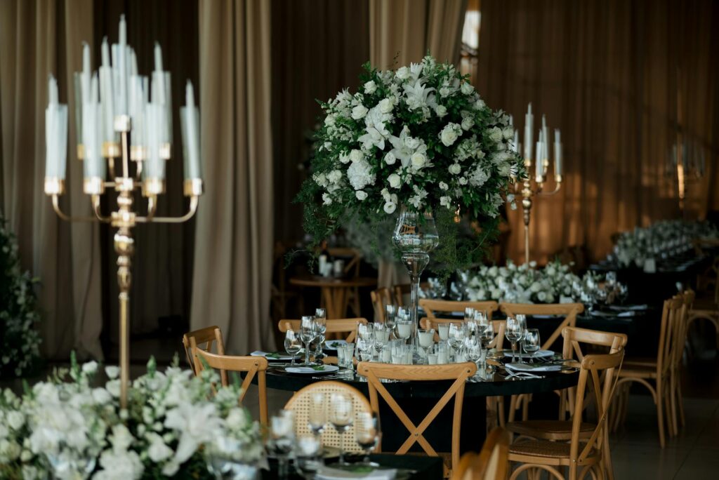 An elegant wedding reception setup featuring floral arrangements and lighting. — Las Vegas wedding packages
