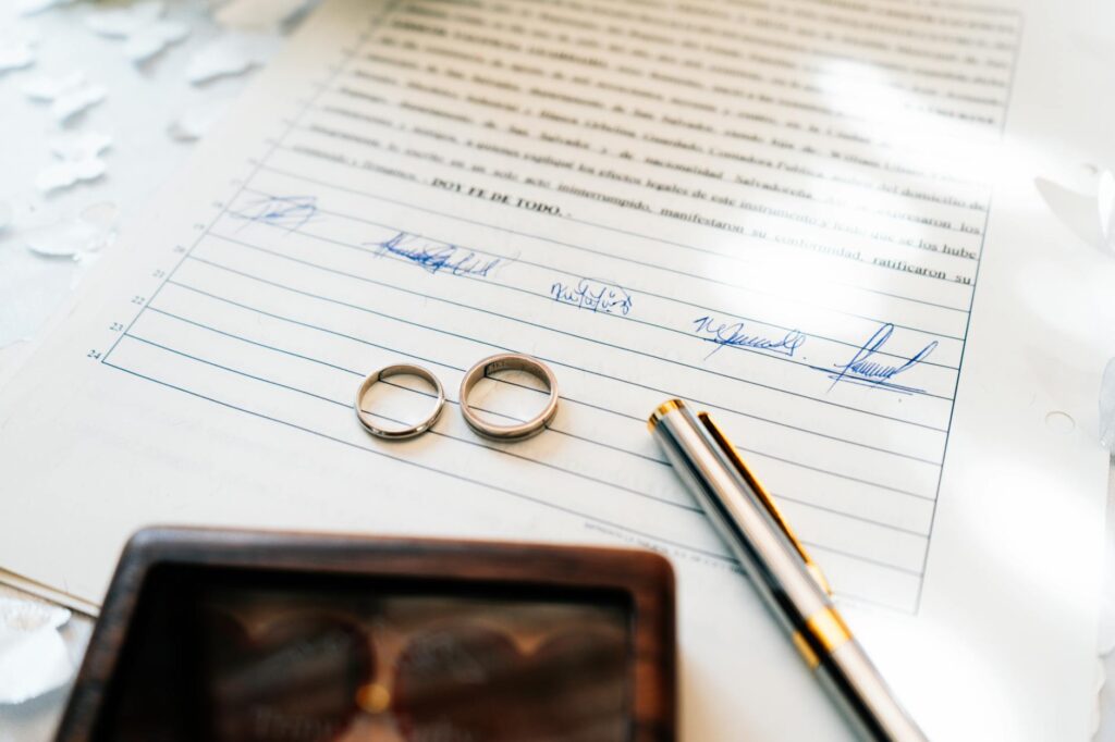 An officiant completing the marriage paperwork with a happy couple. — Las Vegas wedding officiants