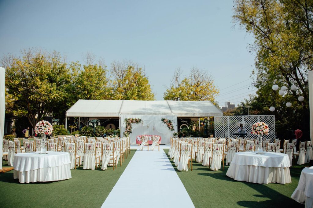 An outdoor garden wedding setup featuring fairy lights and floral arrangements. — Las Vegas wedding themes