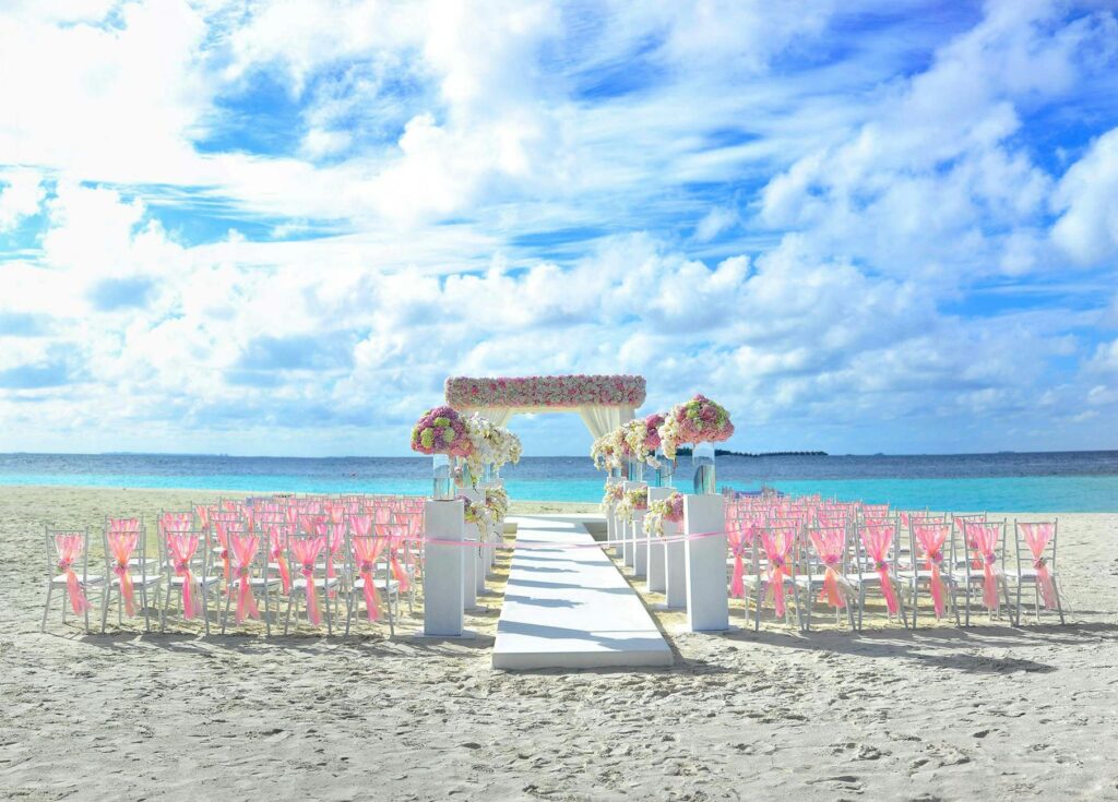 An under-the-sea wedding setup with aquatic decorations and a beach backdrop. — unique wedding themes Las Vegas