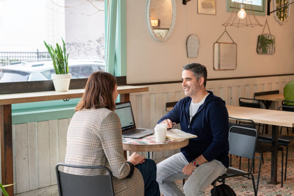 Couple meeting with a wedding planner at a coffee shop. — hiring wedding planner Las Vegas