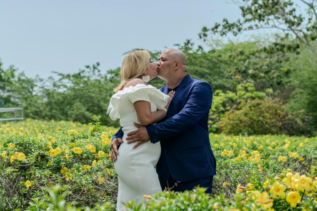Couples enjoying a spring wedding outdoors surrounded by blooming flowers and greenery. — best time to get married Las V…